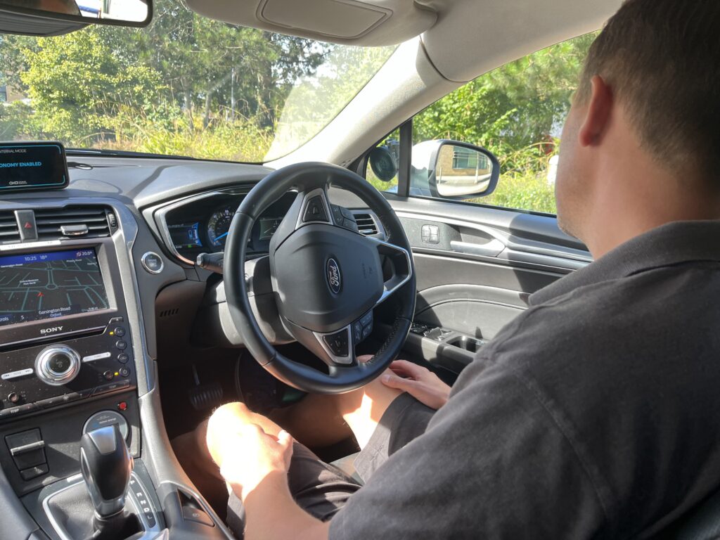 Oxa self-driving car with safety driver, Aug 2024
